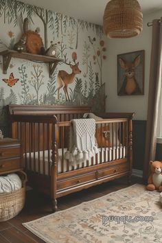 a baby crib in a nursery with deer wallpaper on the walls and rugs