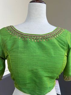 Parrot Green Color Raw Silk Readymade Blouse with beautiful Handwork Work. Item : Readymade BlouseSize : 36 (Can be opened to Size 40)Length of the Blouse : 14 inches Length of the Sleeves : 10 inches Color : Parrot Green Blouse Fabric : Soft Silk Lining : Yes, it is fully lined Padded or Non-Padded : PaddedClosure: Back Closure with hooks.Ready-to-Wear : YesDisclaimer - : -This is a Standard Size blouse. We do not guarantee perfect fit as every body and shape is different. Little or no alterati Blouse Handwork, Parrot Green, Padded Blouse, Readymade Saree, Saree Blouses, Nehru Jackets, Readymade Blouse, Green Blouse, Blouse Fabric