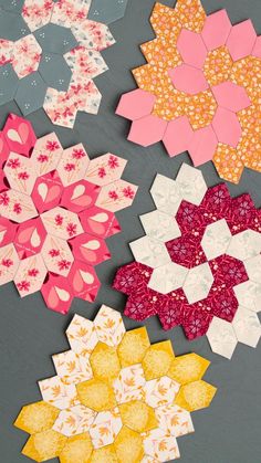 four different types of paper flowers on a table