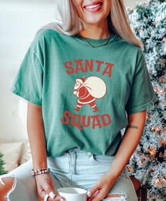 Get into the festive spirit with this Christmas T-shirt featuring a fun 'Santa Squad' design. Made with high-quality, garment-dyed fabric for a soft color and texture, this Comfort Colors 1717 tee is perfect for spreading holiday cheer. Available in sizes S to 4XL, this unisex T-shirt is ideal for men and women looking to add a touch of Christmas joy to their wardrobe. Product features - Available in sizes S to 4XL for a perfect fit - Double-needle stitching for durability - Made with garment-dy Top Christmas Gifts, Christmas Tops, Xmas Shirts, Christmas T Shirt, Christmas Joy, Dyed Fabric, Christmas Tshirts, Soft Colors, Holiday Cheer