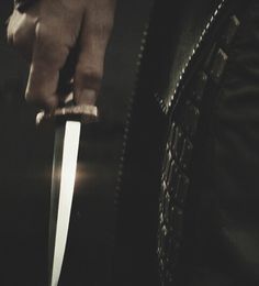 a person holding a knife in their hand