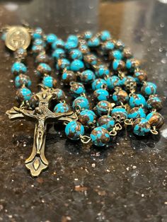 Hand made very strong Rosary. Made with semi precious turquoise 8mm beads, beautiful bronze bead caps , Bronze Findings, a traditional mother Mary Rosary Centerpiece and a traditional Catholic crucifix. This Rosary measures 24 inches.   All of my Rosaries are handmade by myself. I take pride in my work. I use quality and strong products. I make my Rosaries to last so you can enjoy them and pass them down to future generations!  As always, if you have any questions, please don't hesitate to message me. Turquoise Rosary With Round Beads, Spiritual Turquoise Rosary With Round Beads, Turquoise Rosary With Round Beads As Gift, Mother Mary Rosary, Beautiful Rosaries, Catholic Crucifix, Rosary Beads Catholic, Decade Rosary, 8mm Beads