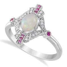 a white opal and pink tourmaline ring with diamonds on the sides, set in