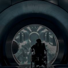 a man in a wheel chair looking into a tunnel