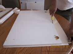 a person is cutting paper on top of a table