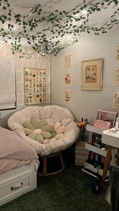 a bedroom with green carpet and lots of pictures on the wall above the bed area