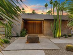 a house with palm trees in the front yard