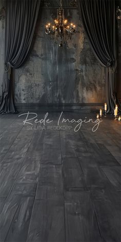 an empty room with chandelier and candles on the floor in front of curtains