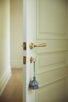 an open door with a blue and white tassel hanging from the handle