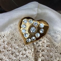 An iconic Christian Lacroix heart brooch.   Paris haute couture, signed fashion jewelry. Stunning French vintage designer jewelry, Lacroix at his most flamboyant. A very big gold heart brooch, chunky and angular, set with 12 sequins that will sparkle brilliantly in candlelight.  A festive brooch in wonderful vintage condition. The Dimensions : Width : 4.5cm/1.6ins Height : 4.5cm/1.6ins Depth : 1.5cm/05ins This brooch will be sent in a linen pouch. Thank you so much for visiting my shop : https:/ Elegant Luxury Heart Brooches, Christian Lacroix Haute Couture, Linen Pouch, Vintage Designer Jewelry, Heart Brooch, Christian Lacroix, Vintage Designer, Gold Heart, Schmuck Design