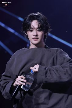 a male in a black shirt holding a water bottle