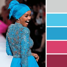 a woman in a blue dress and head scarf on the runway with color swatches