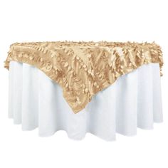 a gold tablecloth with white linens on it and an elegantly designed design