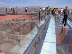 the grand canyon in arizona has many people walking on it and there is a sign that says travel meguade