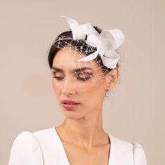 The swirl bow fascinator adorned with veiling sits on comfortable double headband. The headband is made of millinery wire, firm, but bendable so you can adjust it to your headsize or hairstyle. The headband is wrapped in silk, either in beige or black colour. It can be easily placed to any hairstyle, to loose or short hair.  The headpiece is hand made of premium sinamay using traditional millinery technique.  Colour: white If you would like to customize, do not hesitate to contact me:) Double Headband, Bridal Fur, Veiled Hats, Feather Headpiece, Bridal Fascinator, Wedding Veil Accessories, Bride Hat, Bridal Hat, Birdcages