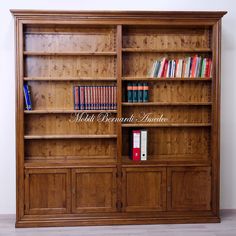 a wooden bookcase with many books on it