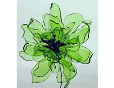 a green glass flower on a white background