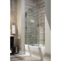 a white bath tub sitting next to a walk in shower