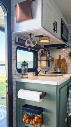 a kitchen area with a sink, stove and window in it's side wall