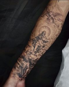 a man's arm with tattoos on it and an image of the virgin mary