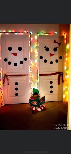 two snowman doors are decorated with christmas lights and decorations for the front door to decorate