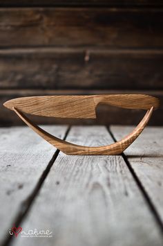 a wooden object sitting on top of a wooden floor