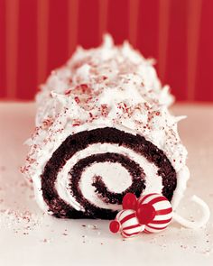 a chocolate roll with white frosting and candy canes