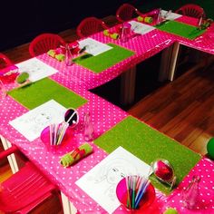 the table is set with pink and green place mats