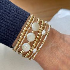 Band (Flat Woven): Horizontal Stripes Band is 1/4"w with 14k gold-filled clasp & 1" extender chain. Strands (Stretch Style): 14K gold-filled 2mm-5mm round beads. Glass seed beads. 10mm freshwater coin pearls. 20x15mm Magnesite oval puff. 5x7mm freshwater rice pearls. More plain gold ball individual bracelets are available here. More seed bead/gold ball individual bracelets are available here. Also available in 14K rose gold fill or sterling silver by email request. White Pearl Stretch Bracelet Dainty Style, Adjustable Pearl Beaded Bracelets Stackable, Adjustable Stackable Pearl Beaded Bracelets, Stackable Pearl Bracelets With Round Beads, Pearl Bracelet With Spacer Beads, Adjustable Stackable Pearl Bracelet, Stackable White Pearl Bracelet, White Stackable Pearl Bracelet, White Pearl Stackable Jewelry