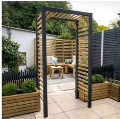 an outdoor garden with wooden planters and trelliss