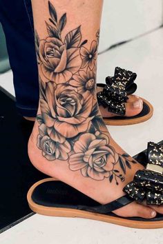 a woman's foot with flowers on it