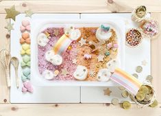 a white plate topped with lots of food next to confetti and candies