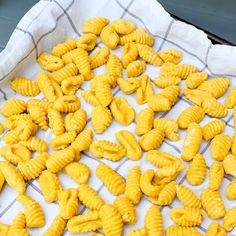 some yellow macaroni shells are on a towel