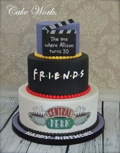 a three tiered cake with the words friends written on it's side and an image of a movie clapper