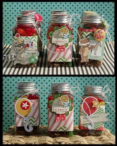 four jars filled with candy sitting on top of a table