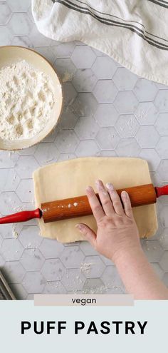 a person rolling out dough on top of a table with utensils next to it