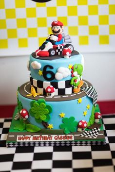 a birthday cake is decorated with mario kart