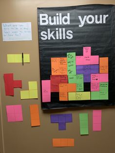 a bulletin board with sticky notes attached to it and the words build your skills written on it