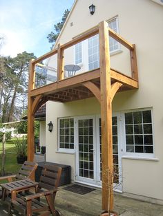 an outside view of a house with wooden furniture