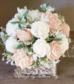 a bouquet of flowers sitting on top of a wooden table