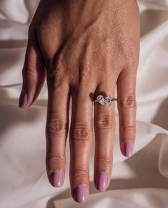 a woman's hand with a diamond ring on it