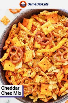 cheddar chex mix in a bowl with the title game day eats on it