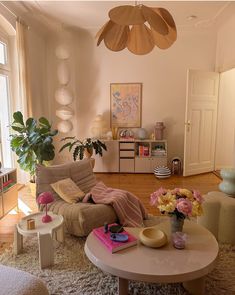 a living room filled with lots of furniture and flowers on top of a coffee table