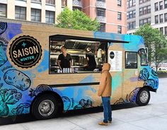 a person standing in front of a food truck