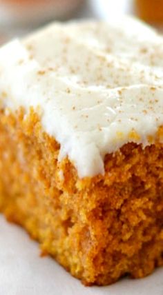 a piece of carrot cake with white frosting on top