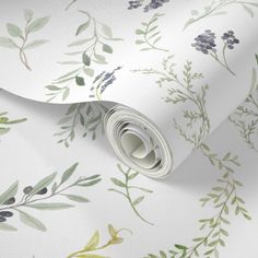 a white wallpaper with green and purple florals on the outside, along with a roll of tape