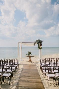 an outdoor ceremony set up on the beach