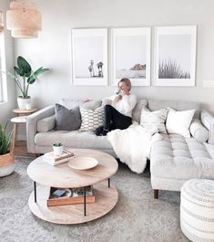 a woman sitting on top of a couch in a living room