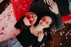 two people laying on the floor with their faces painted red