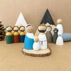 a group of wooden figurines sitting next to each other on top of a table